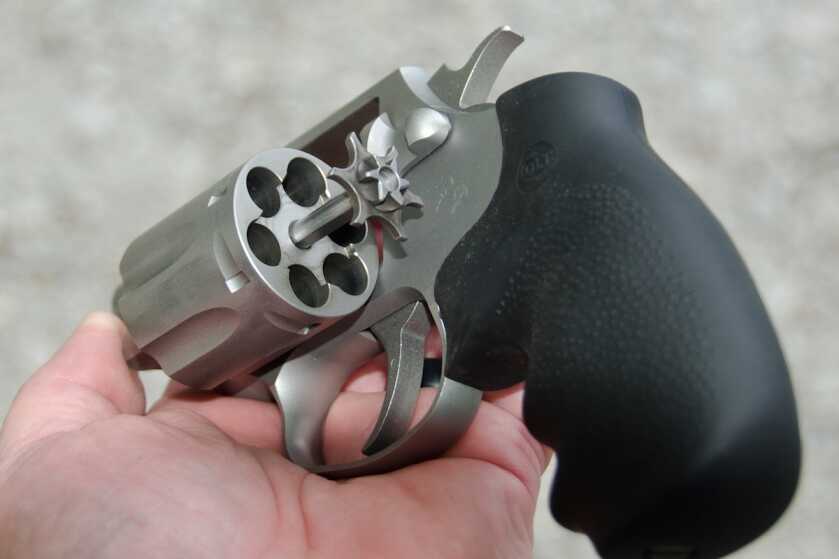 Colt Cobra ejector rod extended from the six-shot stainless cylinder