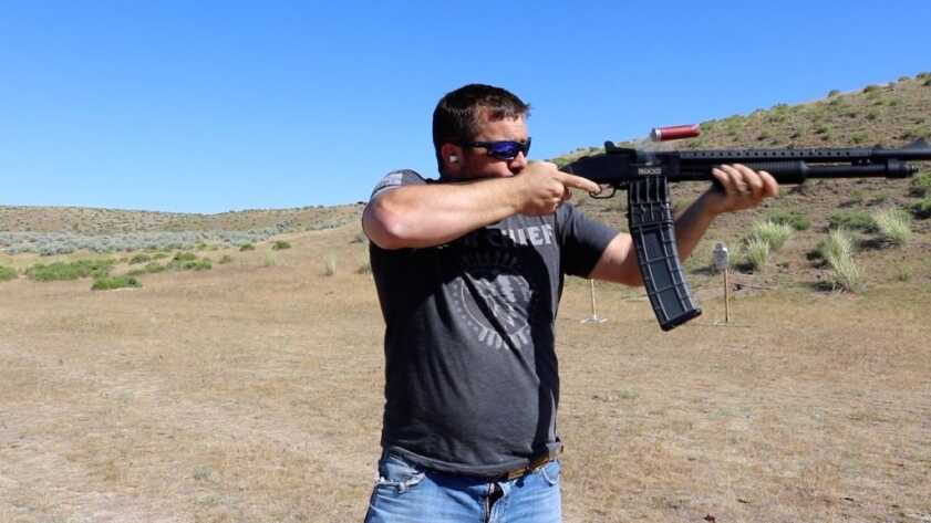 The Best Mag-Fed Shotguns Man shooting Mossberg 590 shotgun outside