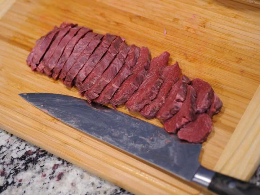 Slicing Bear Meat for Beijing Bear Bear meat sliced 1/4 inch thick across the grain for a tender Beijing bear recipe