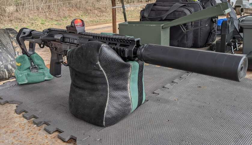 Handgun secured in a shooting rest for a repeatable pistol red dot zero