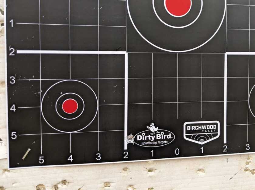 First close-range shot on a paper target at 25 yards while zeroing a rifle red dot