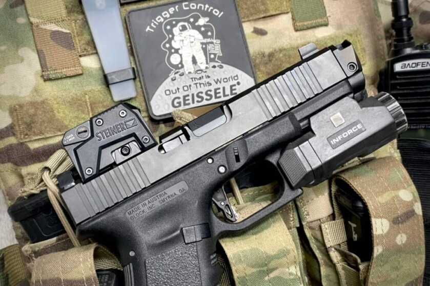 Steiner MPS: Enclosed-Emitter Micro Pistol Sight Review Steiner MPS installed to pistol on camo bag