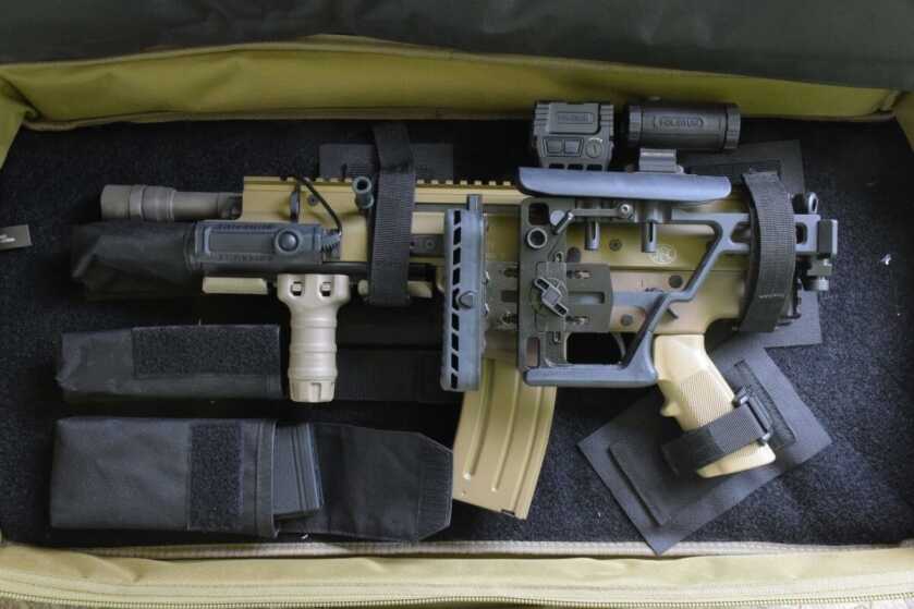 FN SCAR 15P fitted with Holosun optics, TangoDown grip, and Surefire light inside its soft case