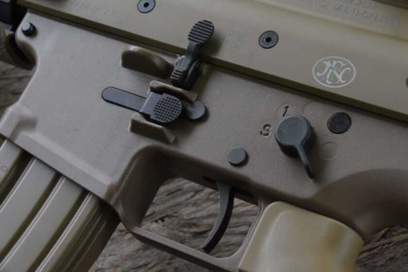 Closeup of FN SCAR 15P receiver showing ambidextrous magazine release and 45-degree safety