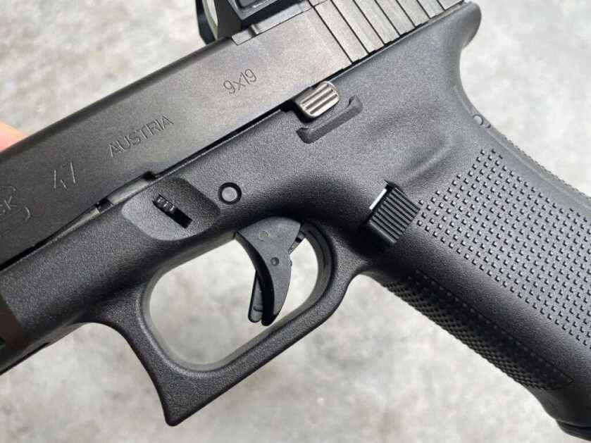 1 - Glock G47 MOS: More Of The Same, Yet Different Enlarged magazine release button on Glock Gen5 pistol.