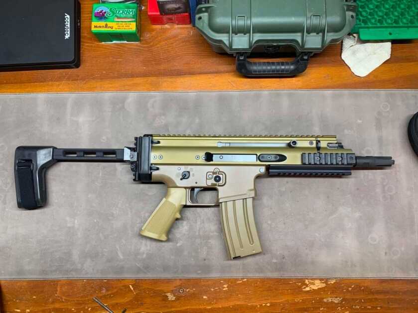 FN SCAR 15P with SB Tactical pistol brace on a work bench