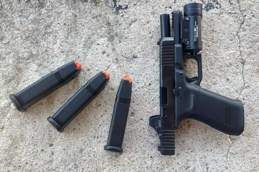 Holosun SCS MOS on Glock 20 resting on concrete after solar powered optic testing