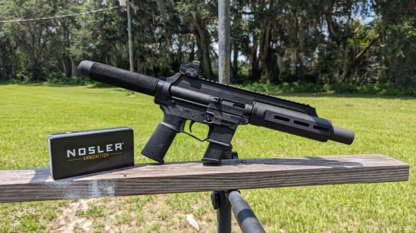 The Extar EP45 - Big Bore Subgun Extar EP45 on wooden bench with Nosler Ammunition