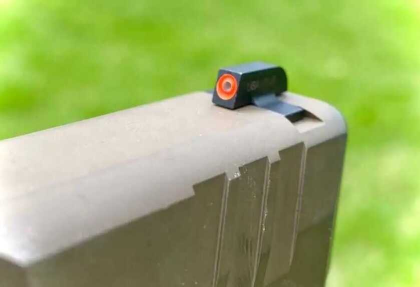 Close-up of the FN Reflex high-visibility orange and tritium front sight