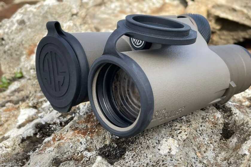 2 - Nature Observation: Sig ZULU8 HDX 10x42 Binocular Review SIG Binoculars with lens covers on colorful lava rock