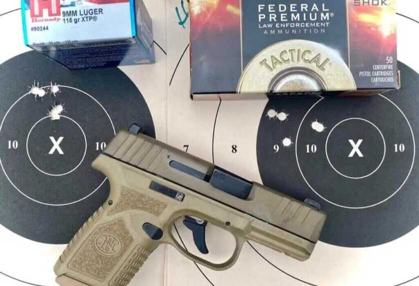 Shooting the FN Reflex 9mm from the bench during 15-yard accuracy testing