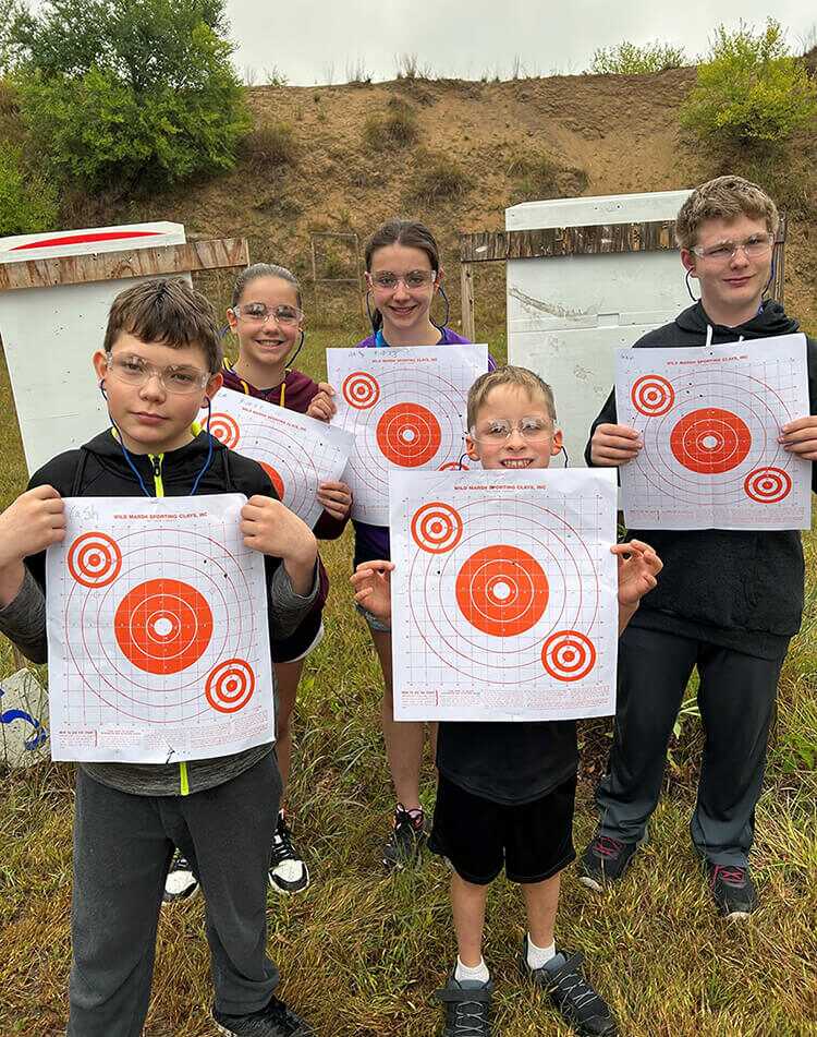 Five youth participants holding up targets.