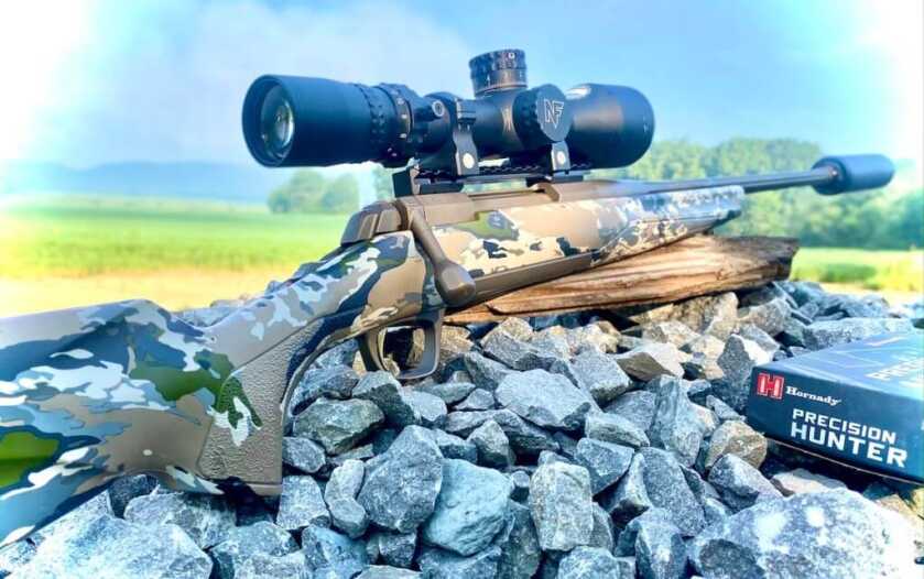 Browning X-Bolt Speed SR 7mm PRC suppressor-ready hunting rifle sitting on rustic rocks beside Hornady ammunition