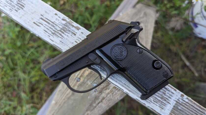 Beretta Tomcat side angle with logo and grip easily visible set on wooden post
