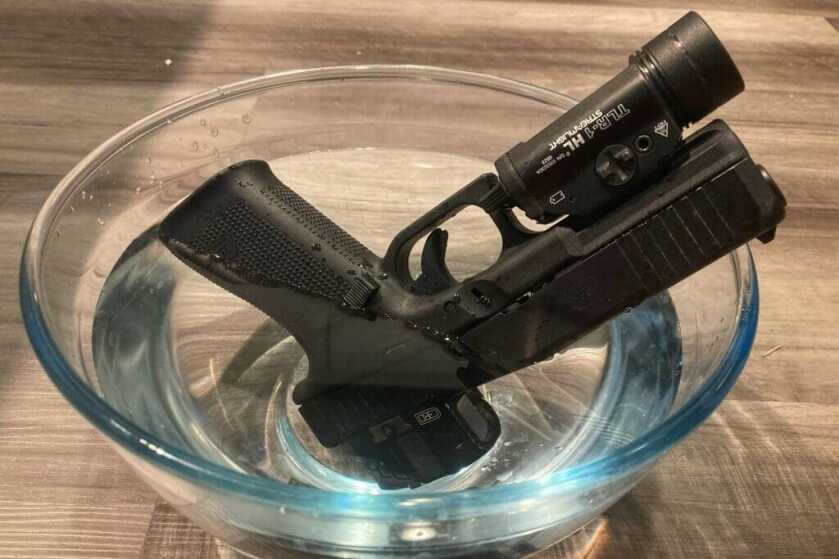 3 - Testing C&H Precision's New Duty Optic firearm with optic in bowl of water running waterproof test