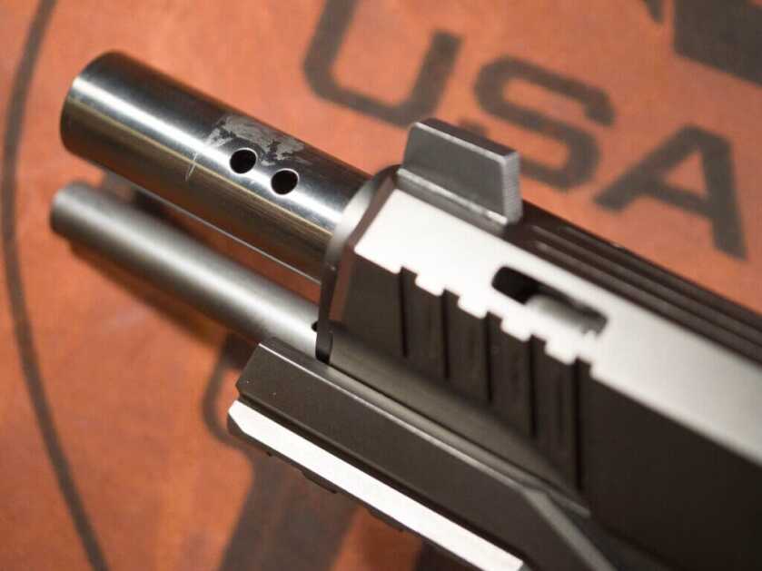 Close up view of the slide open revealing the barrel of the Cabot Guns Insurrection. The slide has windows cut in it, and the barrel has two sets of two-hole ports at 10 and 2.