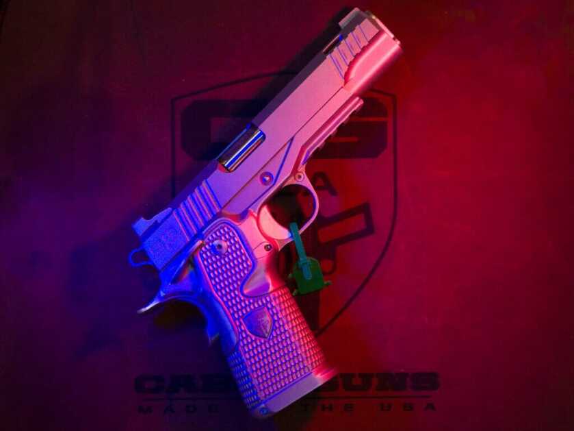 The right side of the Cabot Insurrection 2011. The gun is positioned diagonally pointing to the top right. It is all stainless and lit with a red light on the right and a blue light on the left.