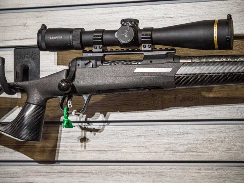 Close up view of the action, trigger, scope, and action with carbon fiber stock.