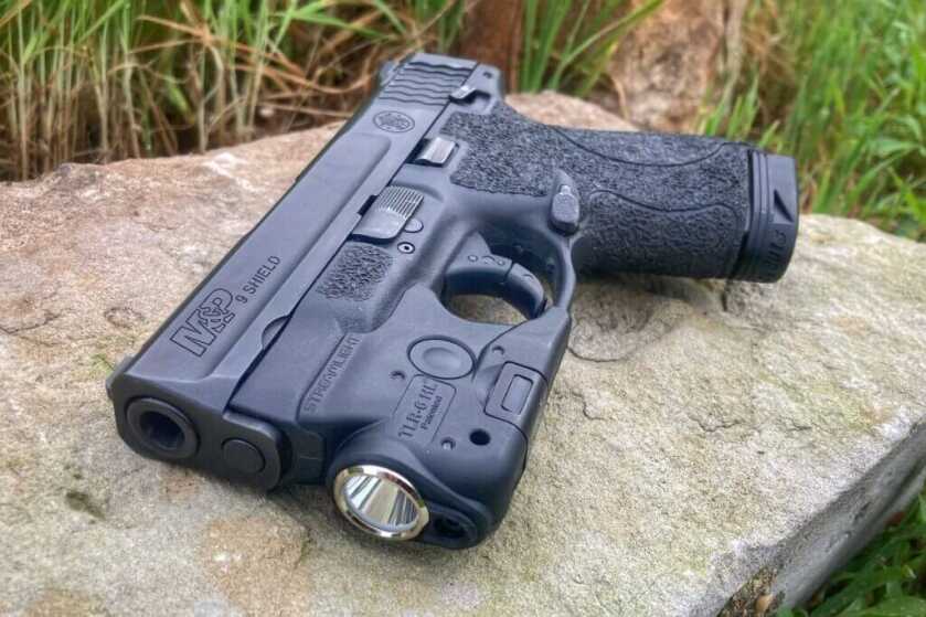 S&W Shield on rock with TLR-6 HL installed