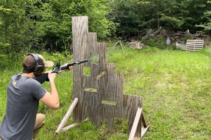 Shooter testing the Smith & Wesson Model 1854 lever-action rifle from a challenging position through a VTAC barricade