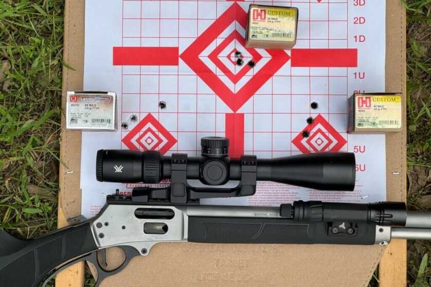 Smith & Wesson Model 1854 .44 Magnum rifle resting across 50-yard paper targets beside test ammunition