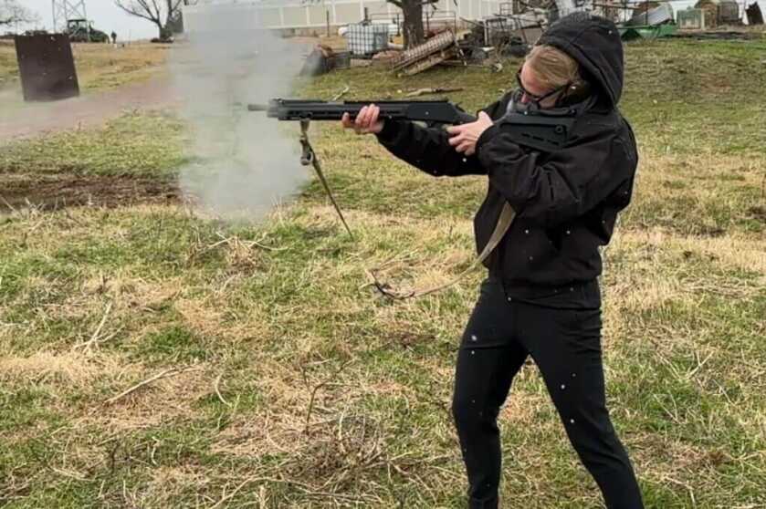 Person in black shooting lever action gun 