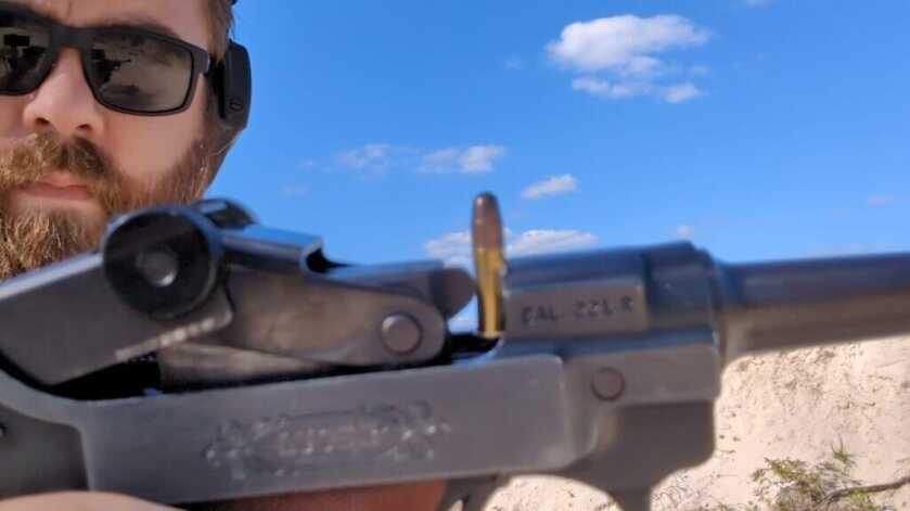 Man with jammed gun