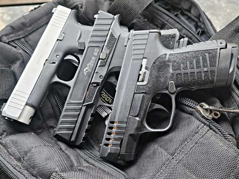 three guns on range bag