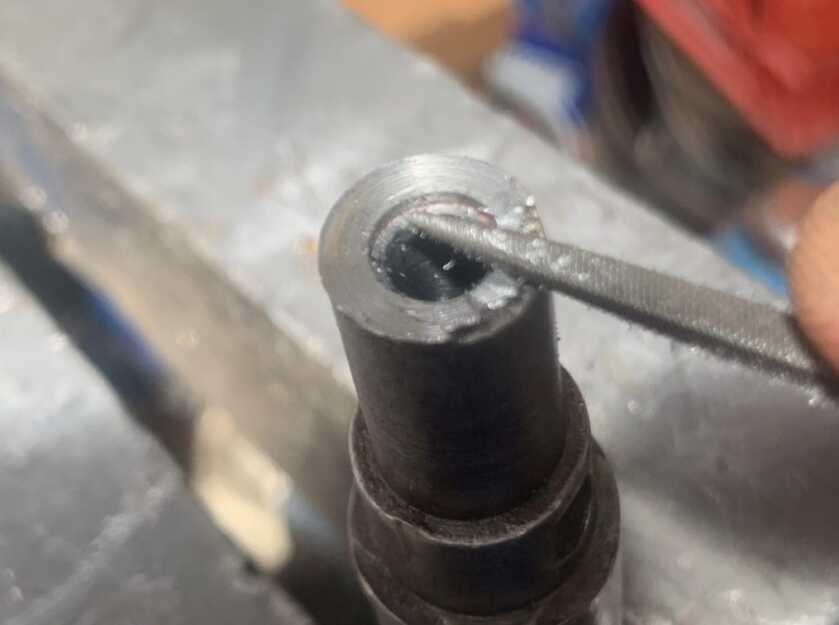 Relining a Barrel, Or How to Make a Barrel Like New Again Using a needle file to relieve the barrel liner for the extractor