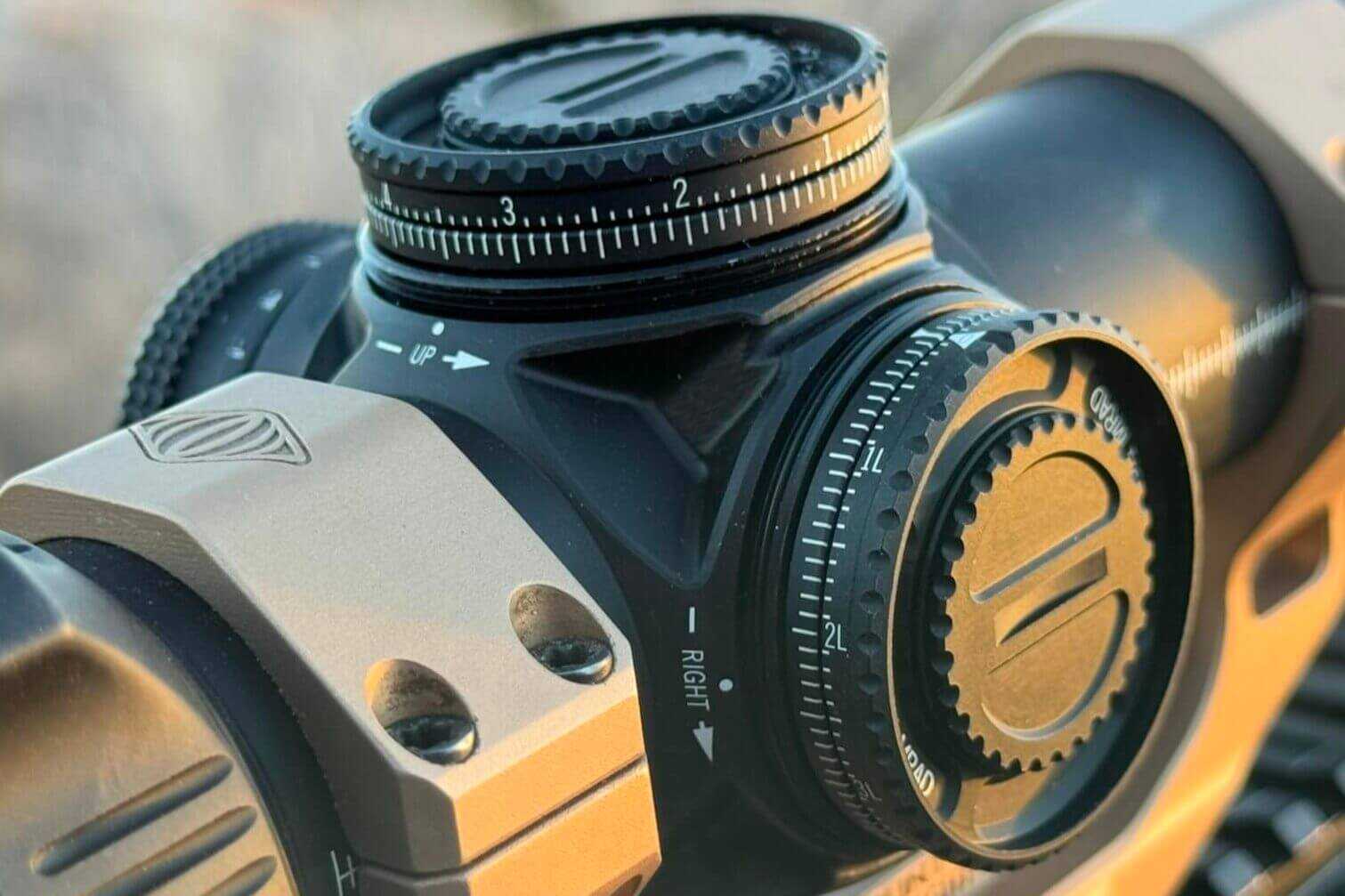 Closeup of AMG 1-10x24 split turret design enabling two mechanical zero positions