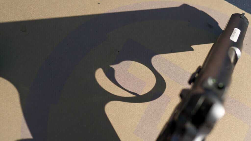 The gun's shadow cast on the table.