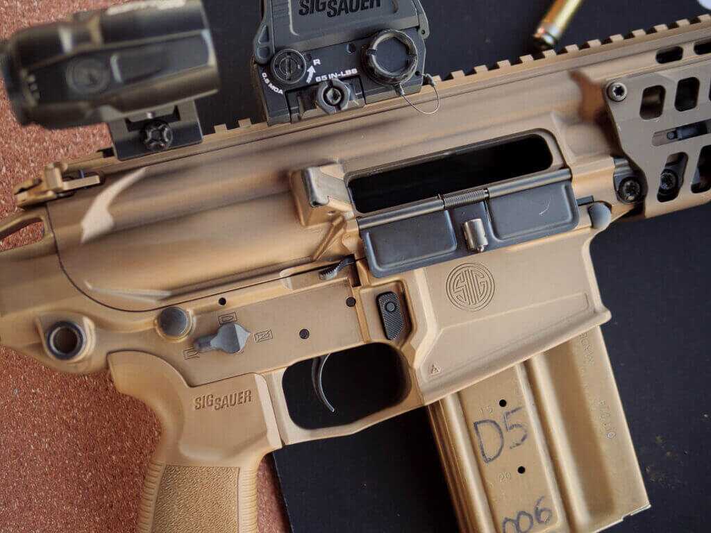 Close up of the right side of the receiver with a magazine inserted.