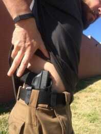 Solving Problems One Hand at a Time By sweeping backward and getting a thumb under the shirt, the author is able to access the handgun quickly and efficiently. The holster shown is the Haley Strategic Partners INCOG by G-Code.