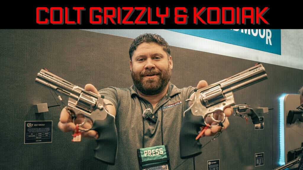 True holding up two revolvers.