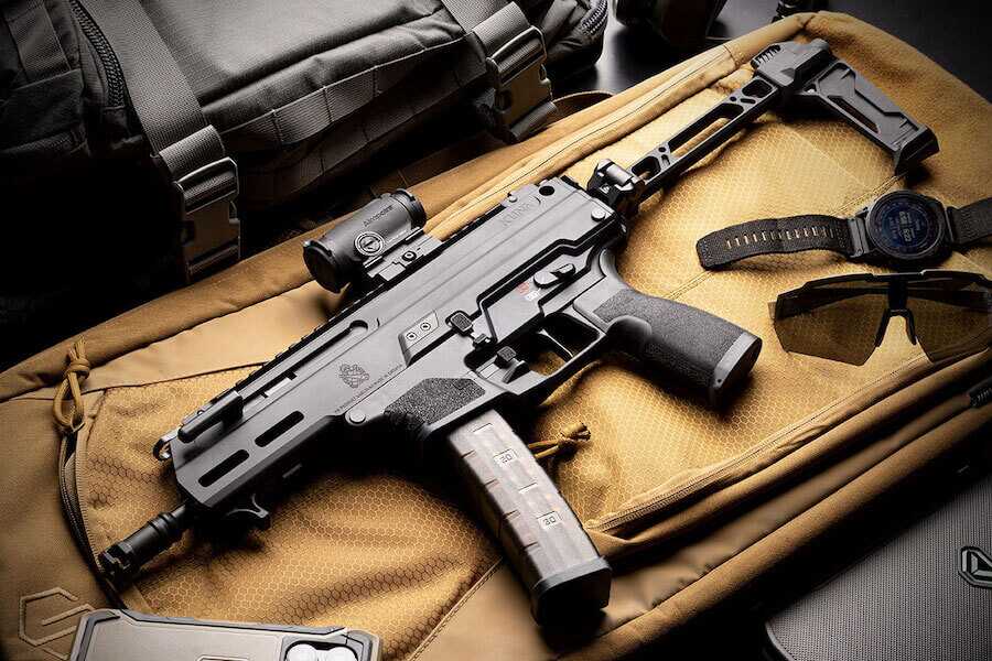 The Kuna PDW pistol placed on a handbag.