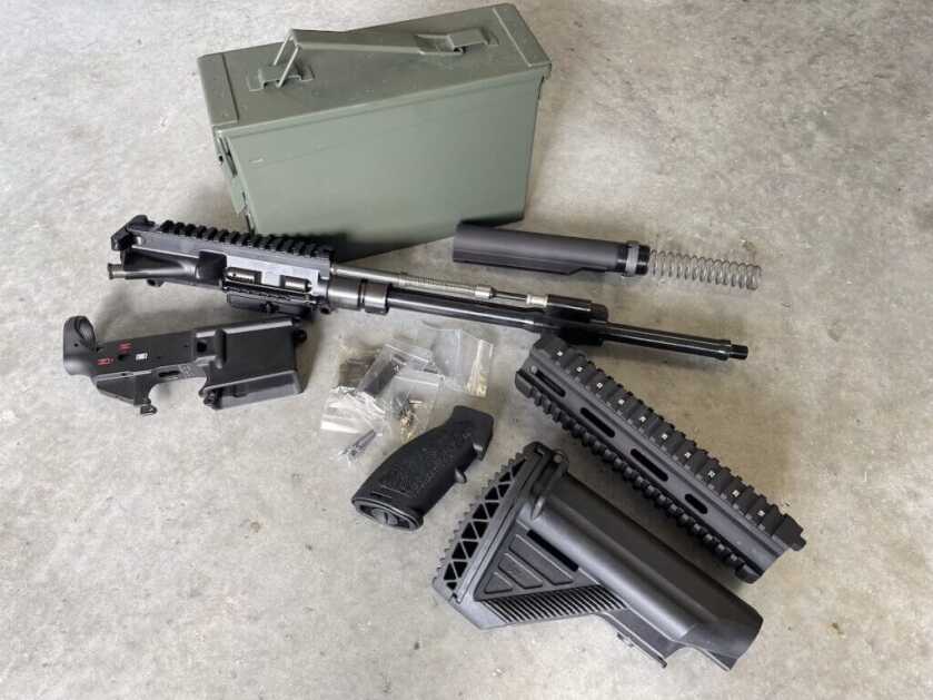 Parts layout for HK416 clone build showing quad rail, E1 buttstock, HK battle grip, and BRN-4 piston upper