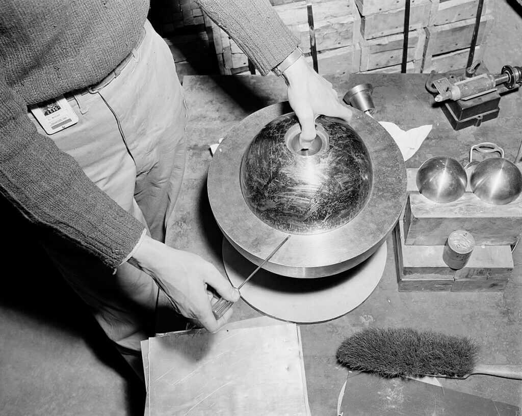Recreation of Slotin’s screwdriver technique holding beryllium hemispheres apart over the Demon Core