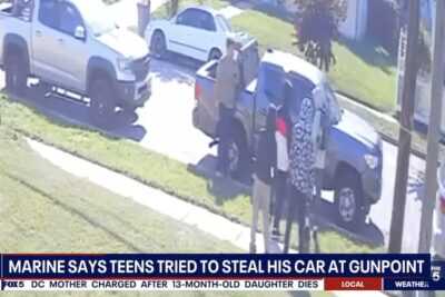 Surveillance camera image shows Marine veteran Jacob Bordeaux standing beside his pickup truck as four teenagers approach him moments before an alleged armed carjacking attempt in Oxon Hill, Maryland.