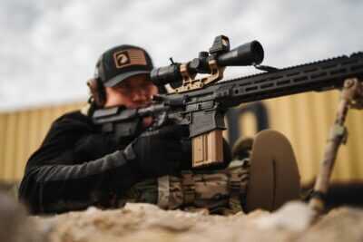 Shooter fires a Primary Weapons Systems MK2 MOD 2-M .308 rifle equipped with a riflescope at an outdoor range.