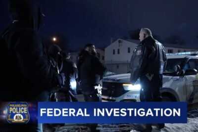 Philadelphia police officers speak with armed members of the Black Lion Party during a January 2026 confrontation that later prompted a U.S. Department of Justice investigation into the city's gun permit revocation practices.