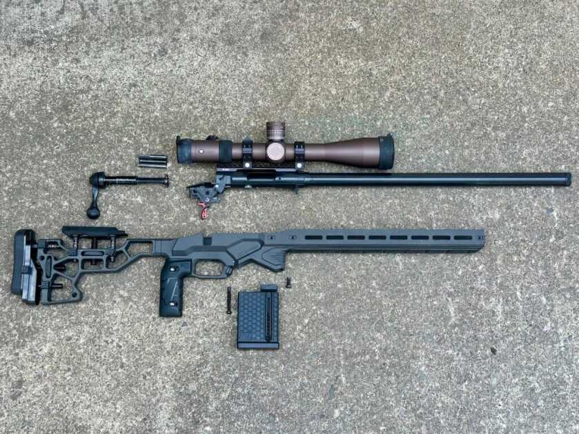 Disassembled Savage 110 RF Elite Precision showing the reversible bolt baffle and full-size Model 110 action