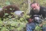 Joelseph Jenkins poses beside an unlawfully harvested black bear during an illegal guiding operation that led to prison time and a lifetime hunting ban in Idaho.