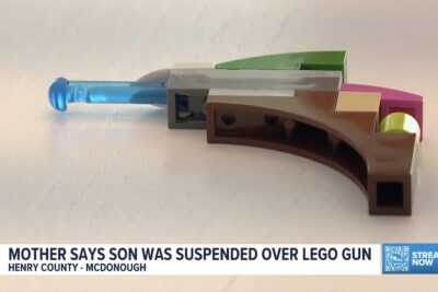 A small LEGO keychain shaped like a toy pistol that led to an 8-year-old Georgia student being suspended from elementary school.