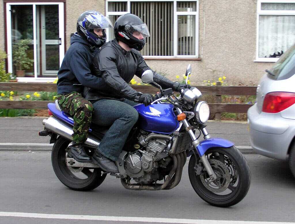 Two men riding tandem on a motorcycle like the pair who approached Ray Davis in Lahore Pakistan