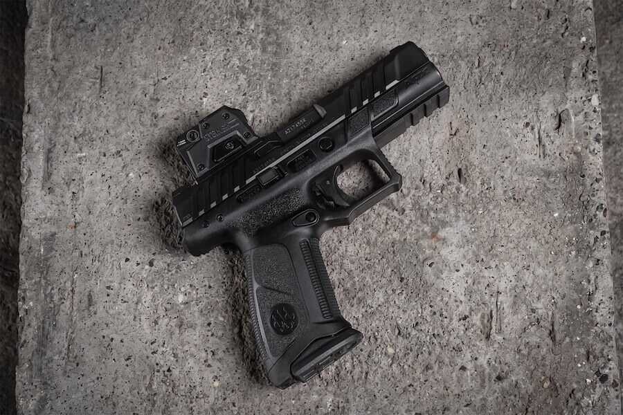 A Steiner MPS 2.0 enclosed-emitter red dot mounted on a full-size optics-ready pistol resting on a concrete surface.