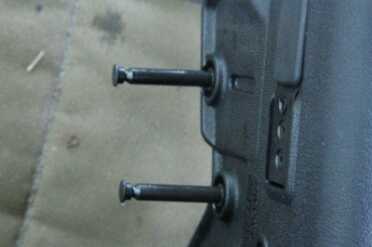 These two captured pins can be opened with a shell casing.