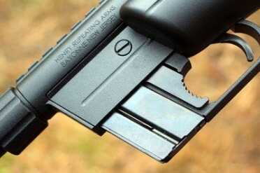 The Surprising Survival Rifle: Henry's AR-7--Review The magazine fits flush with the trigger guard, and is released by the lever that looks like it has a bite taken out of it.