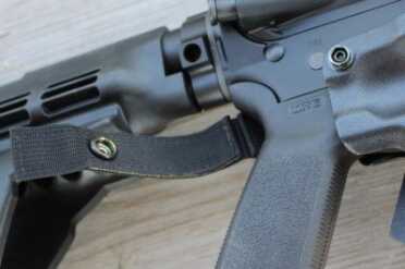 Everyone Needs an AR Holster A reinforced strap holds the gun securely in the holster, but it can be removed.