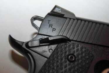 The TRP has ambidextrous safety levers of roughly equal size.