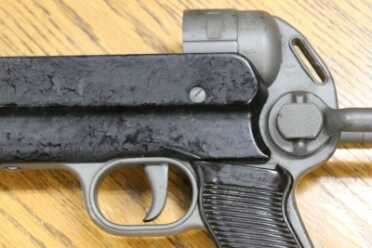 The Legacy of the MP40--Full Auto Review Button to fold stock first under folder made of wire.